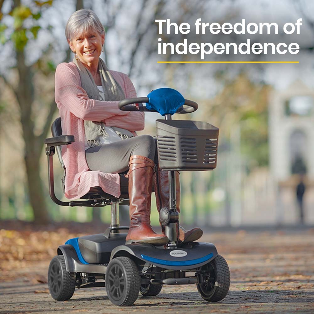 The freedom of Independance text with smiling happy lady on a blue mobility scooter in a nice park setting. 