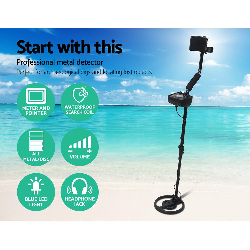 A white sandy beach and aqua marine blue ocean view with a Black metal detector in the foreground  text read professional metal detector and waterproof search coil and all metal discrimination.