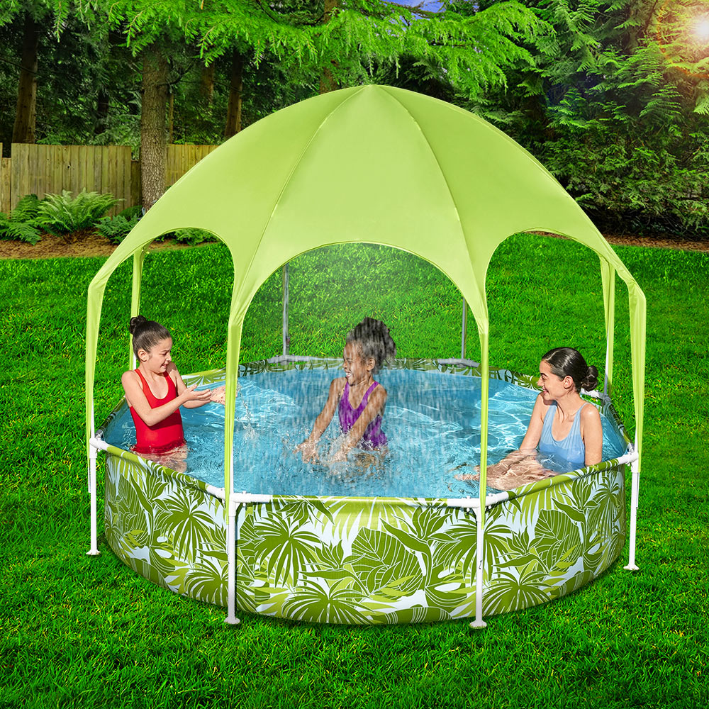 Small above ground swimming pool with shade cover has Mum and 2 girls enjoying themselves splashing and playing.