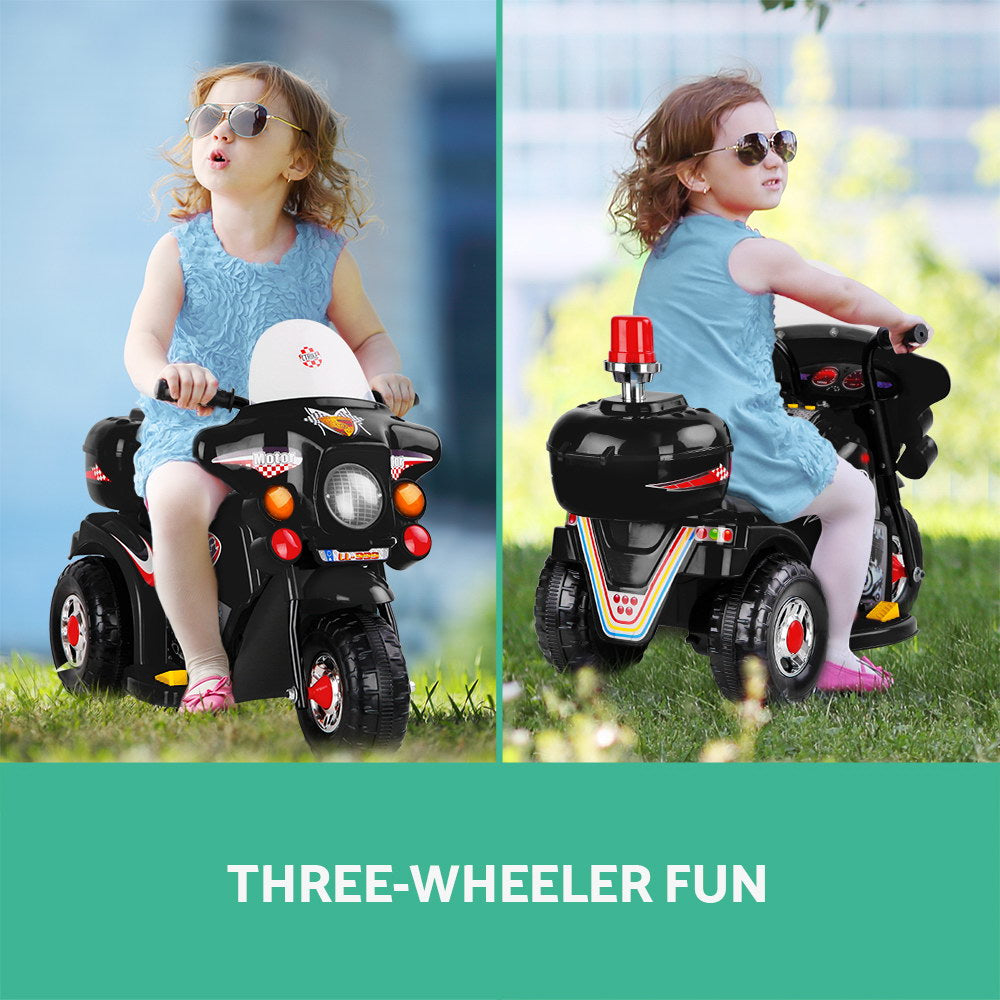 A small girl rides a three wheeled 6v battery motorcycle looking happy and cool in dark glasses.