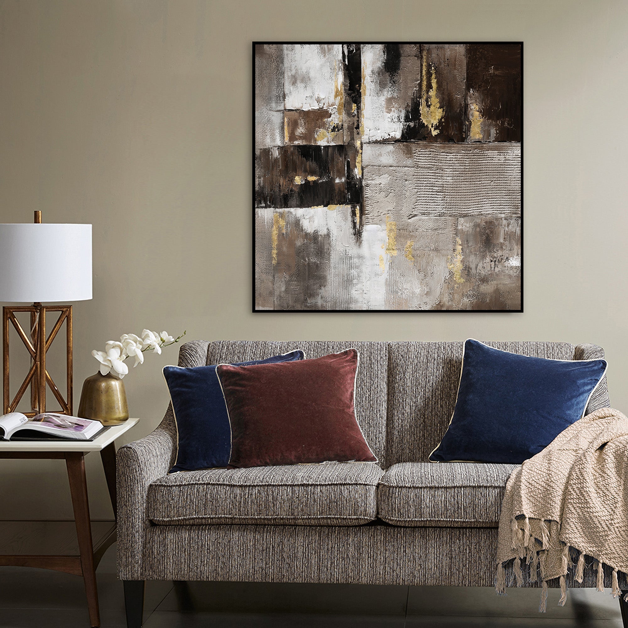 Modern Wall art in comfortable lounge with lamp sofa cushions rug and table lamp with ornaments 